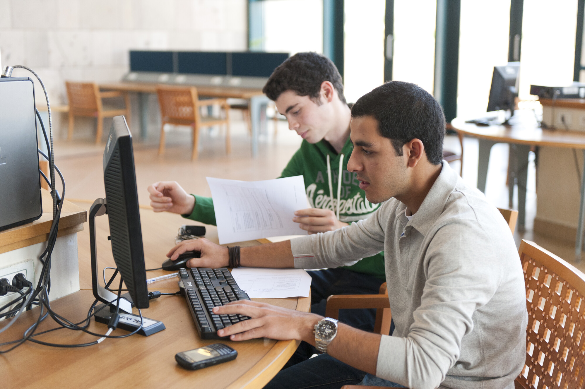 students working on computers in the auc library