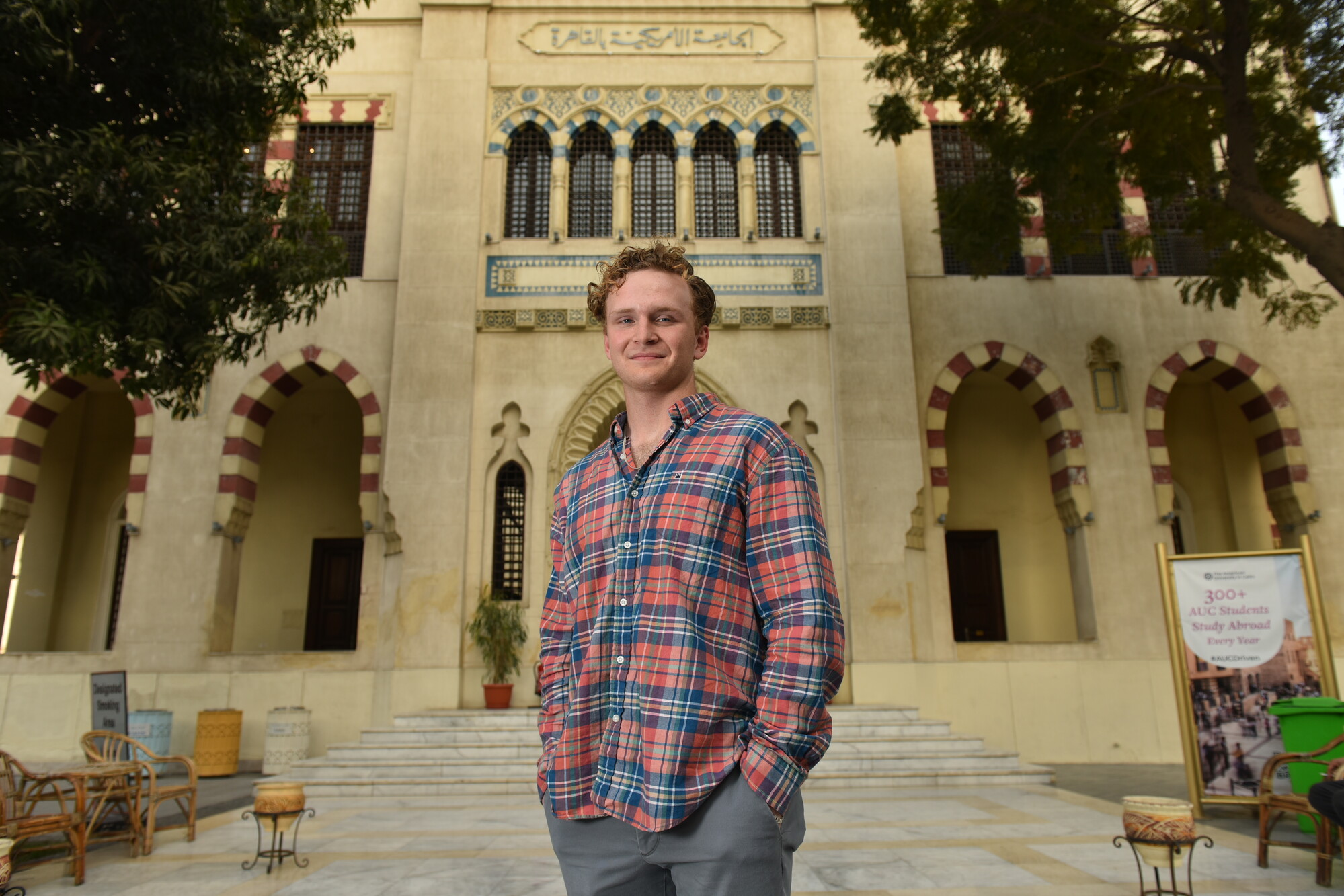 international student in tahrir campus standing infront of building