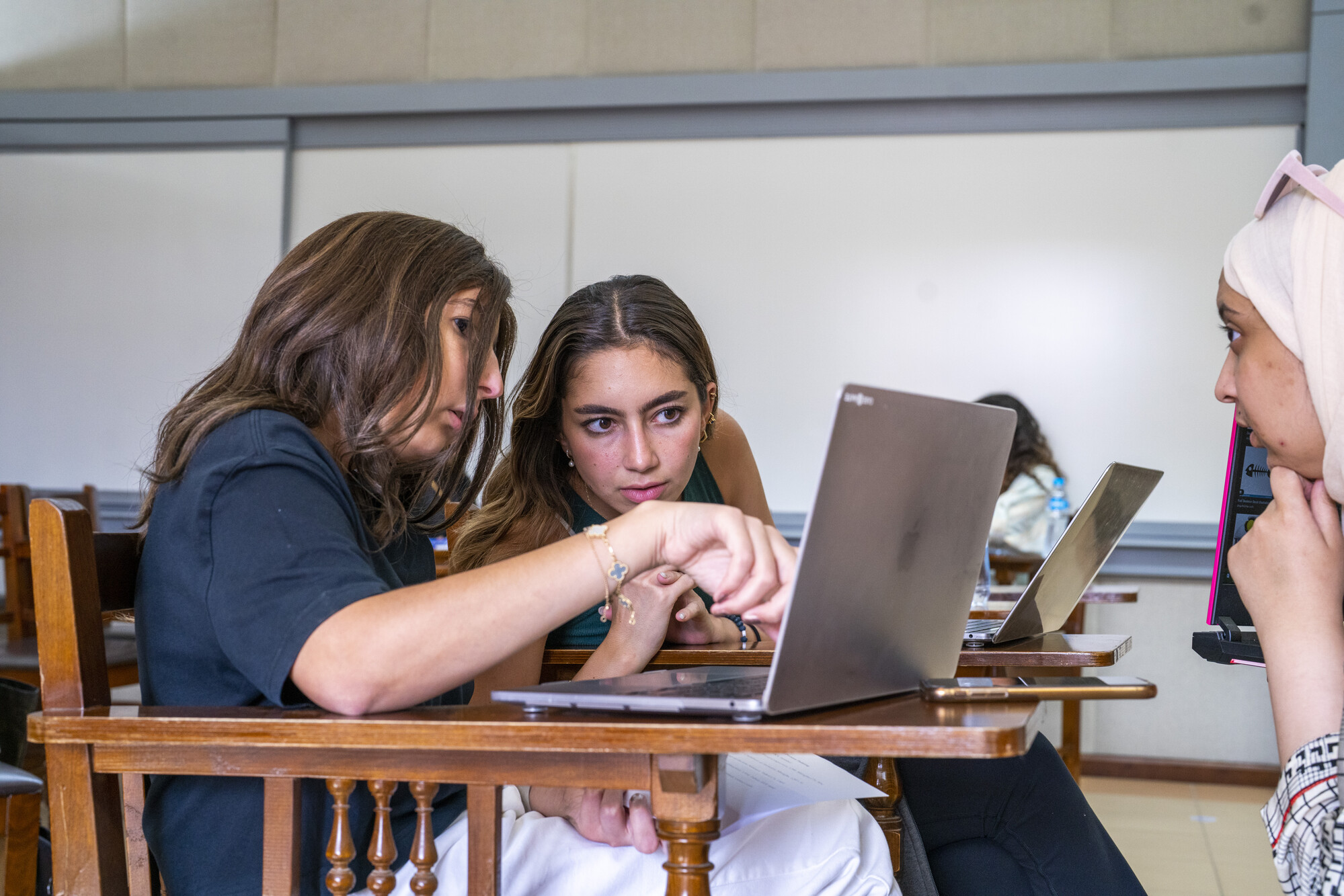 students working in a group on laptop in class project