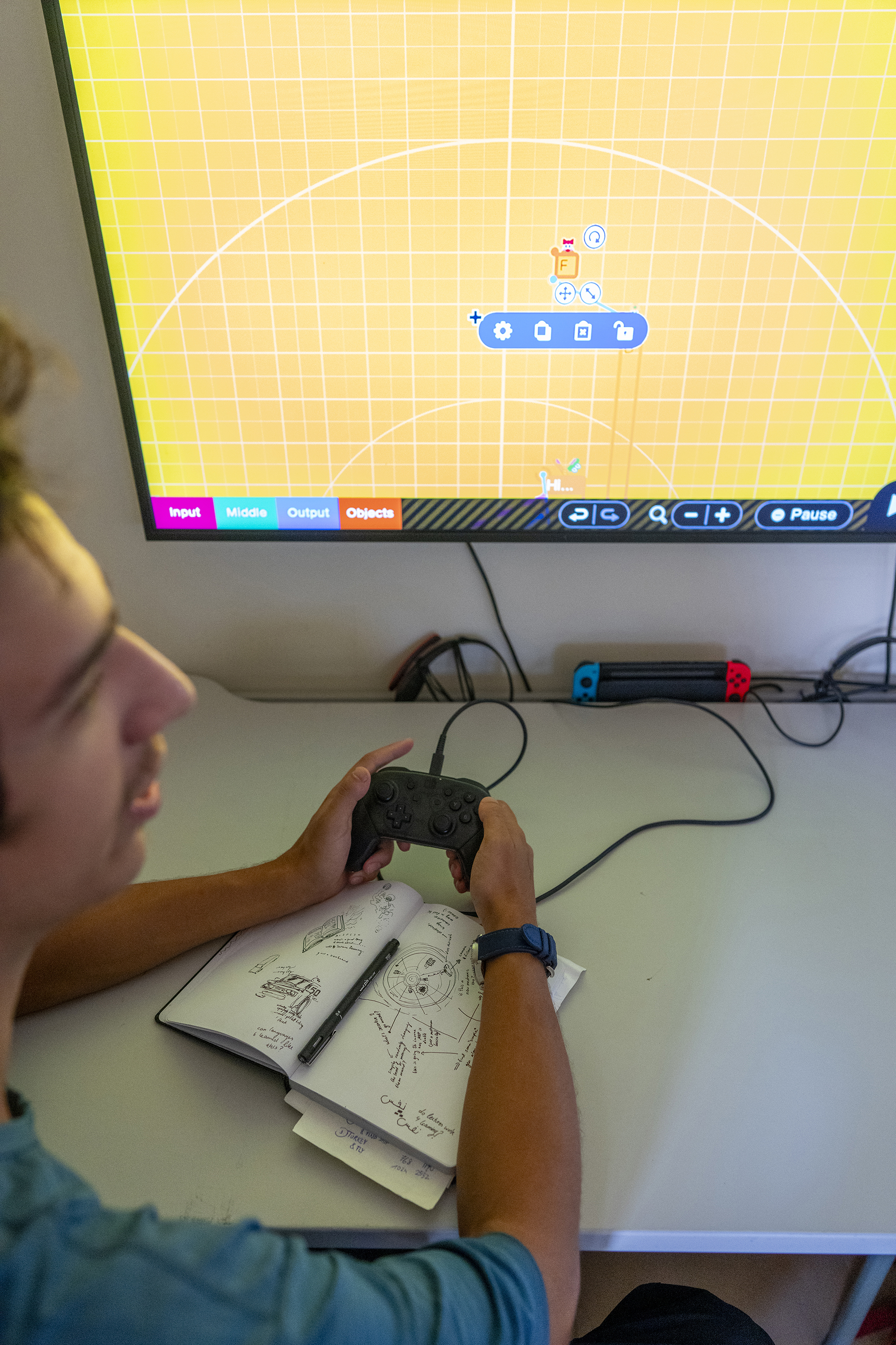 student with a joystick building a game in a class