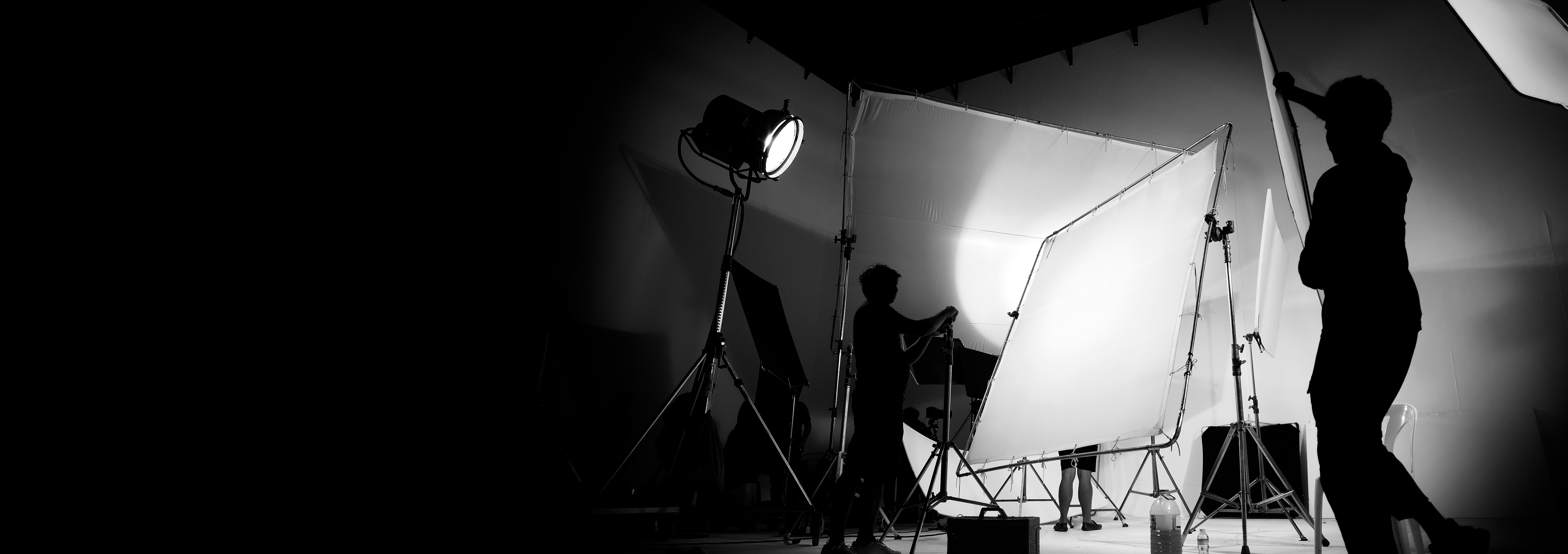 Camera men fixing the lights in the studio