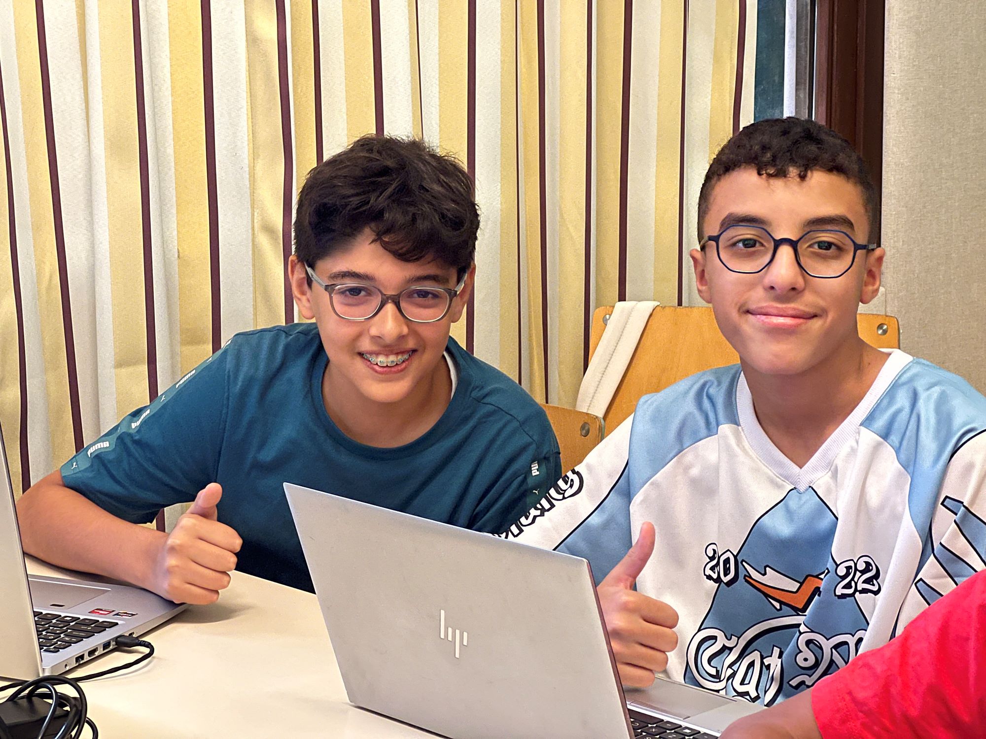 Teenage students in the class with a laptop