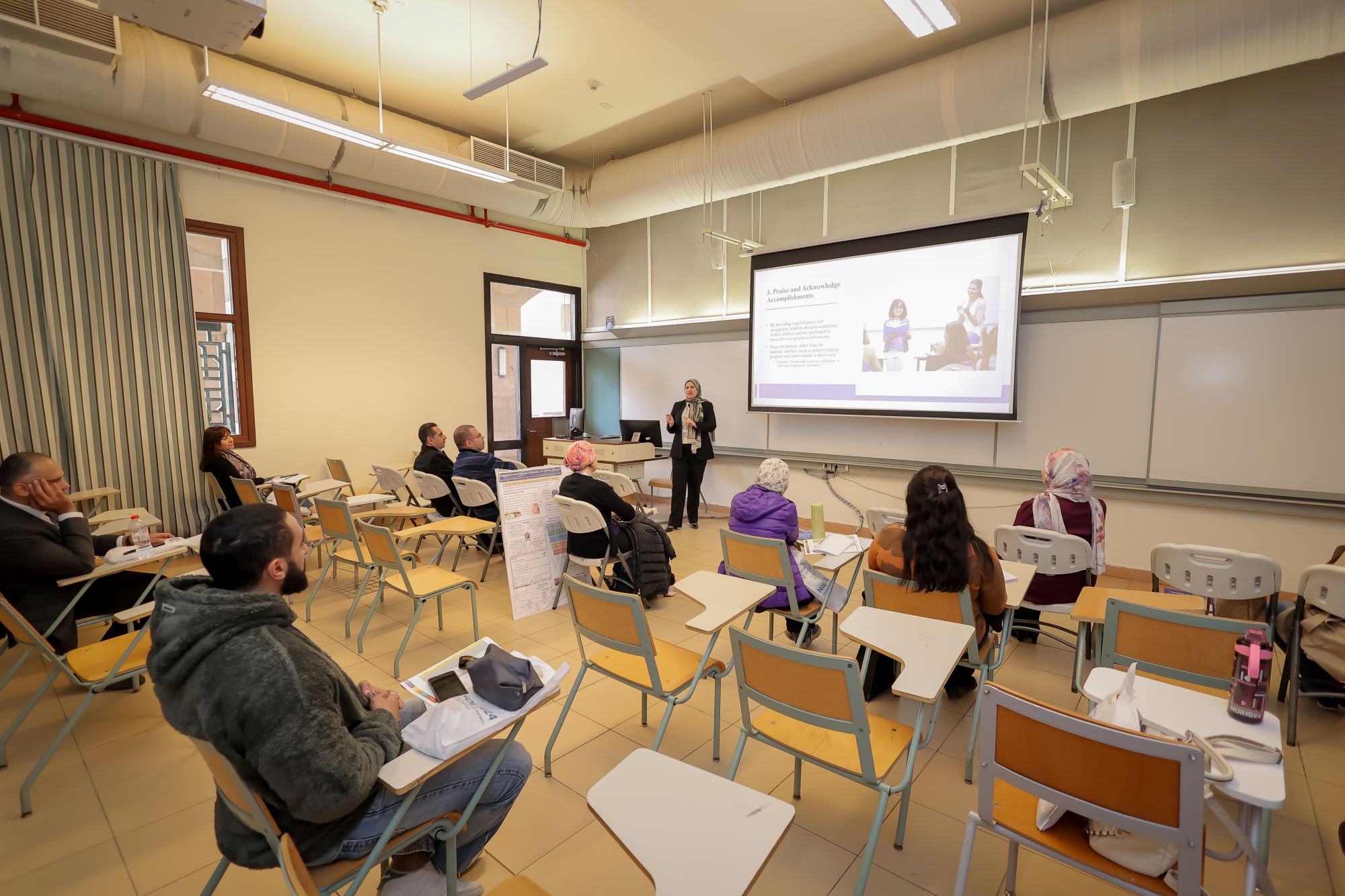instructor explaining to students in a class Brand and Product Management, AUC marketing course