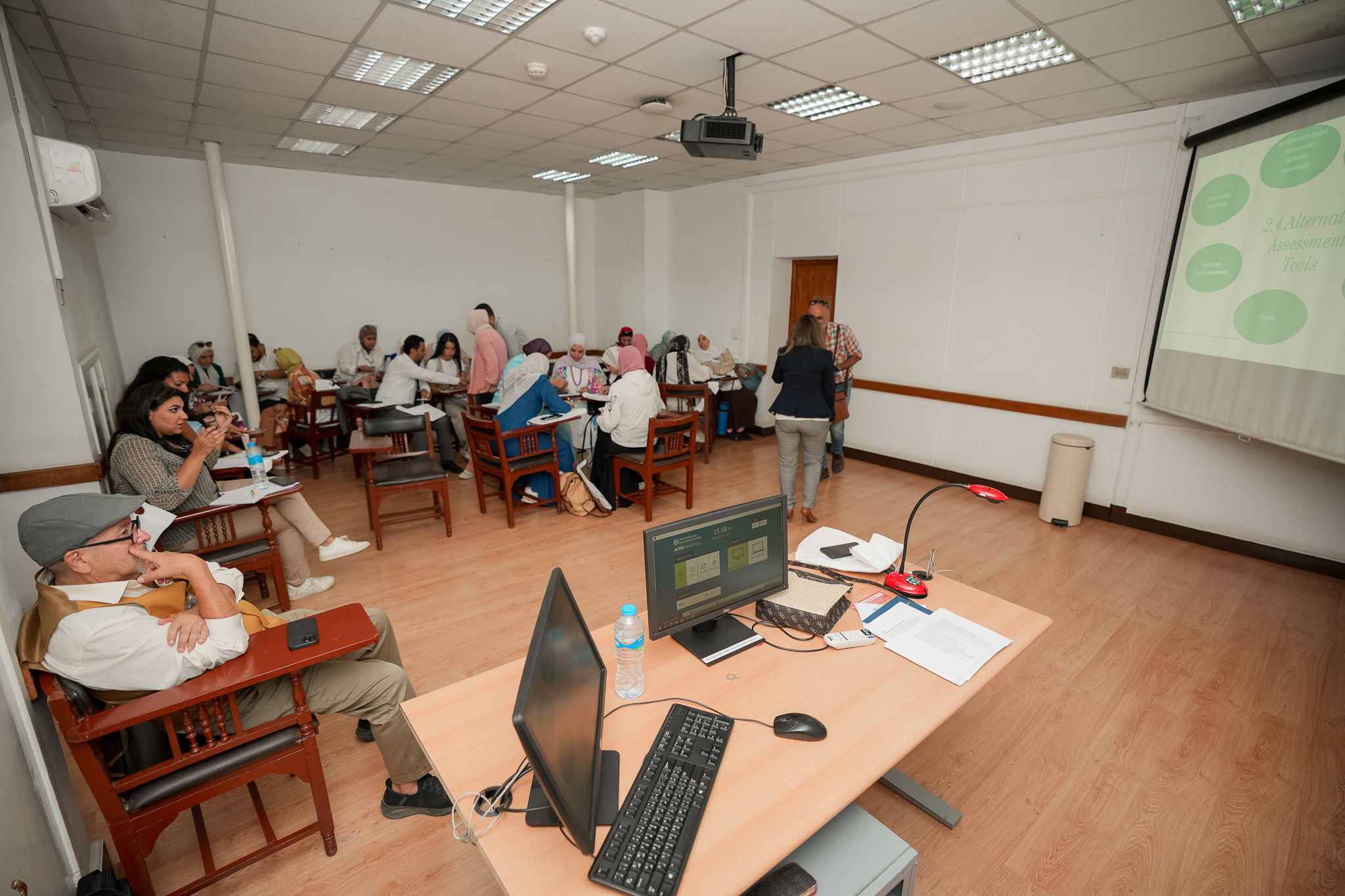 instructor explaining to students in a class Compensation and Benefits at AUC's SCE