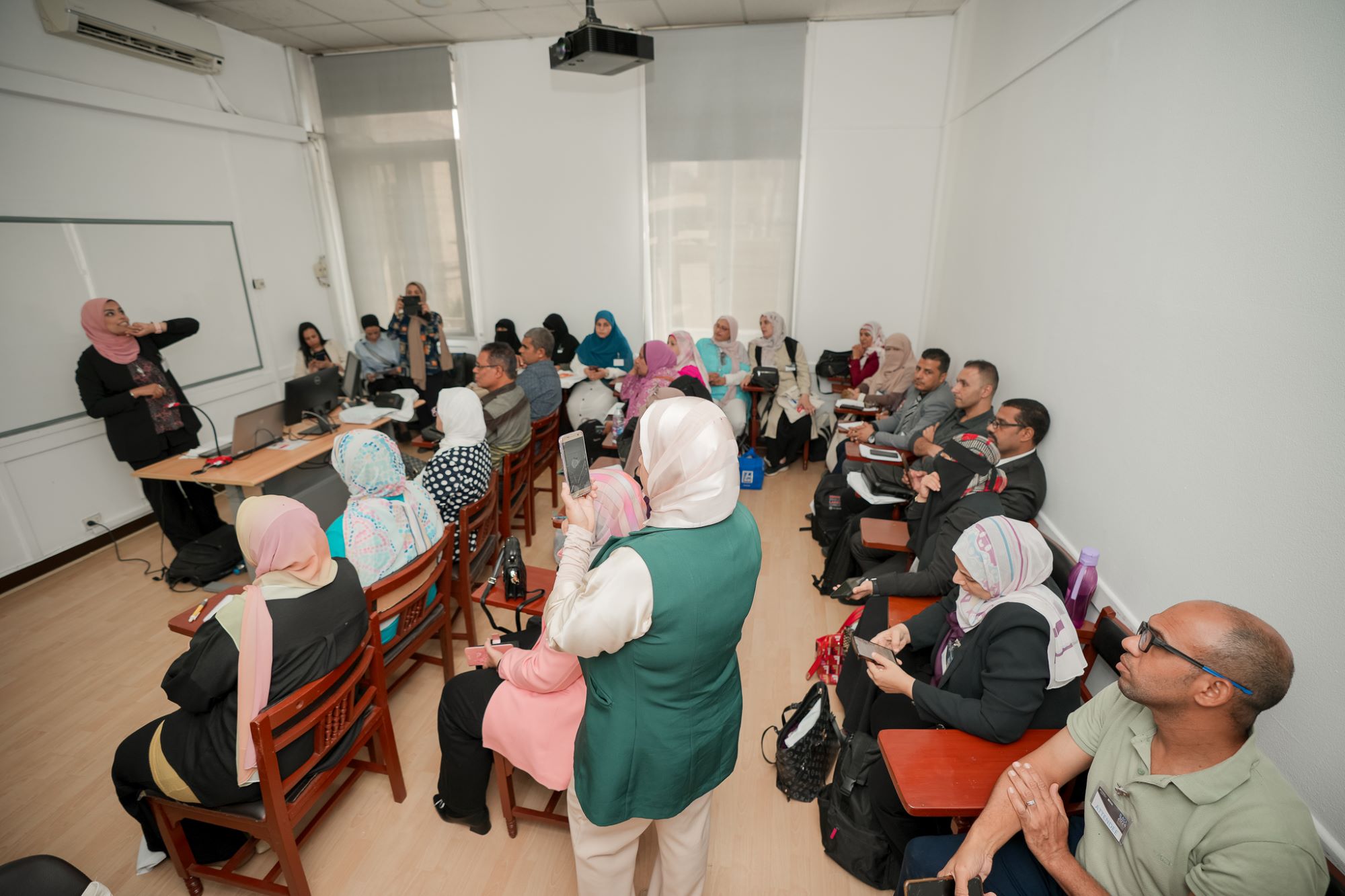 instructor explaining to students in a class Performance Management course at AUC's SCE