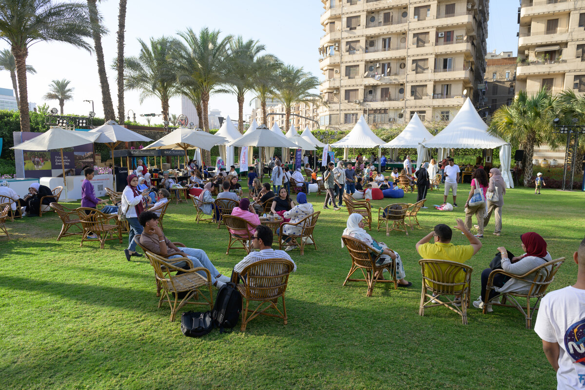 Event on campus with students and parents enjoying garden area