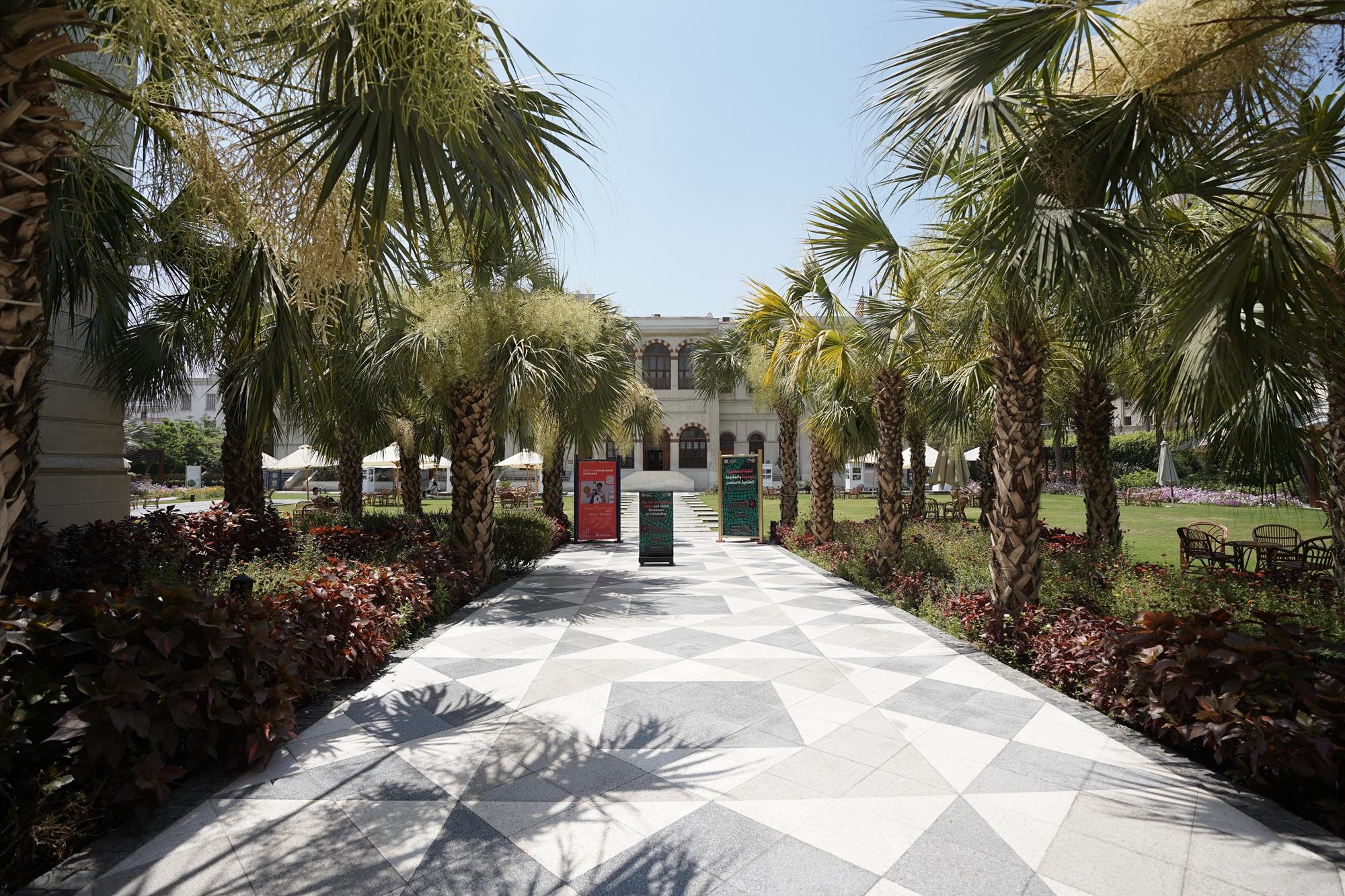 A building with palm trees on the left and right
