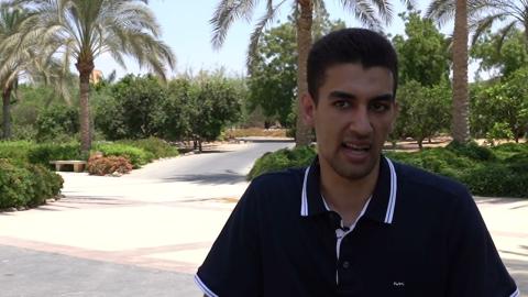 ِA young male is talking in a garden