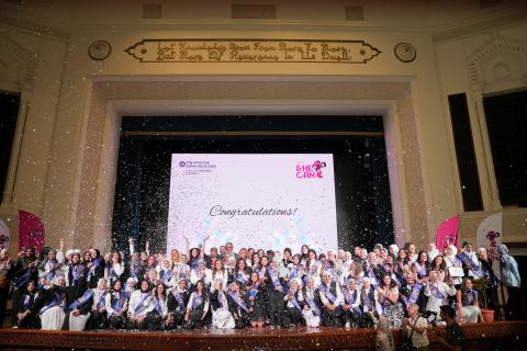 AUC_SCE's She Can program graduates celebrating their graduation on the stage of Ewart Hall