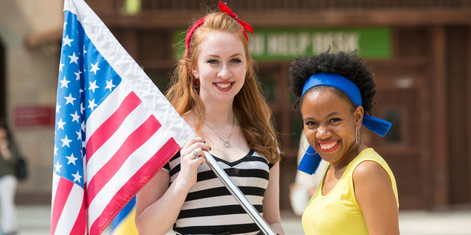 two students holding the american flad