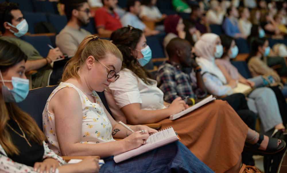 Image of student writing in hall