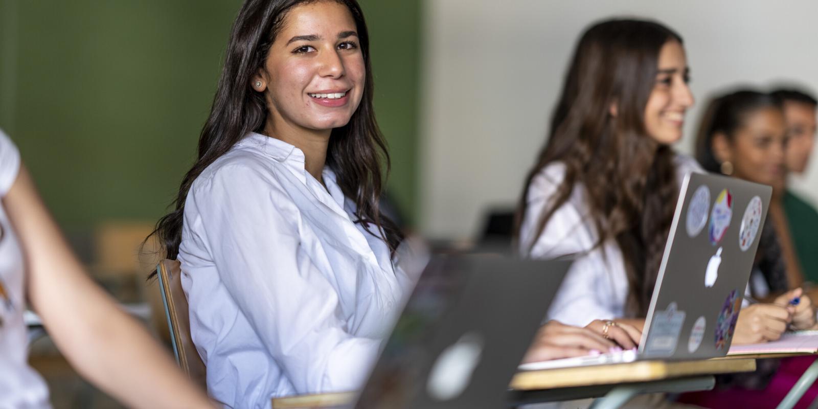 female student smiling in classroom 