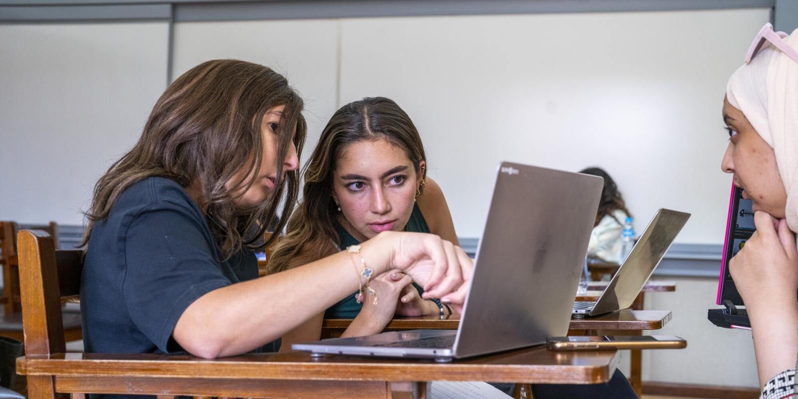 students working in a group on laptop in class project