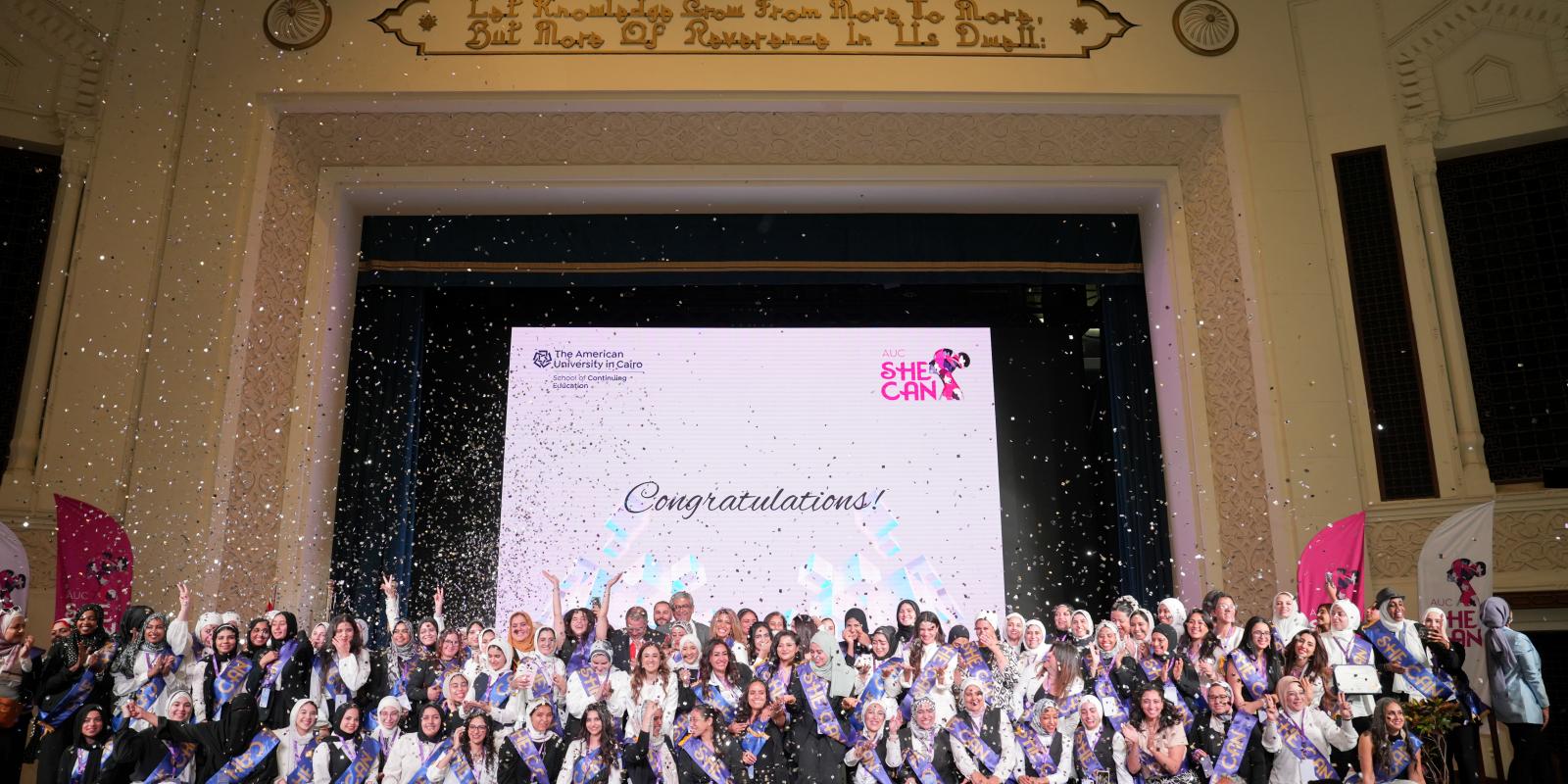 AUC_SCE's She Can program graduates celebrating their graduation on the stage of Ewart Hall
