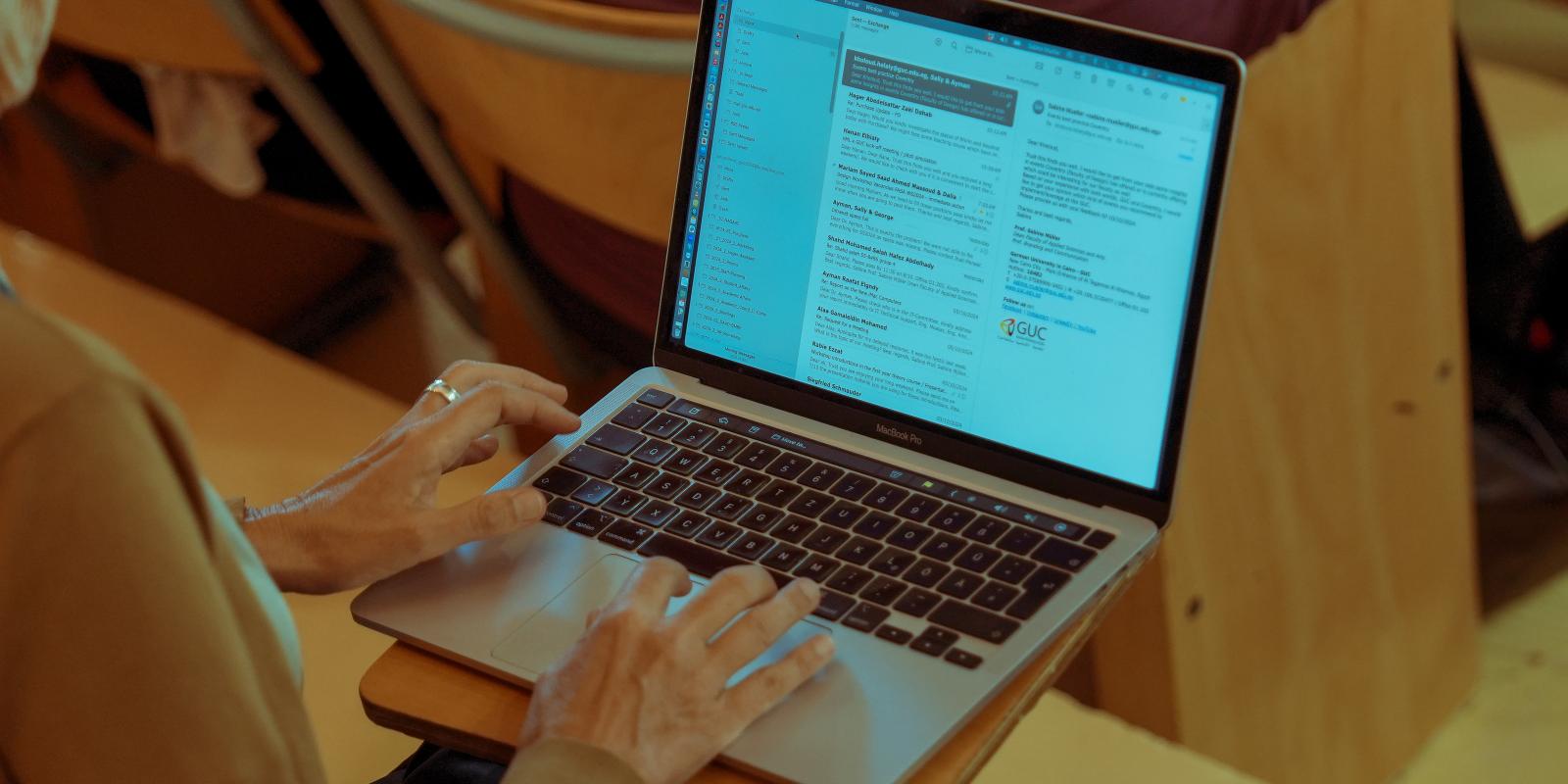 student is following up with class on her laptop
