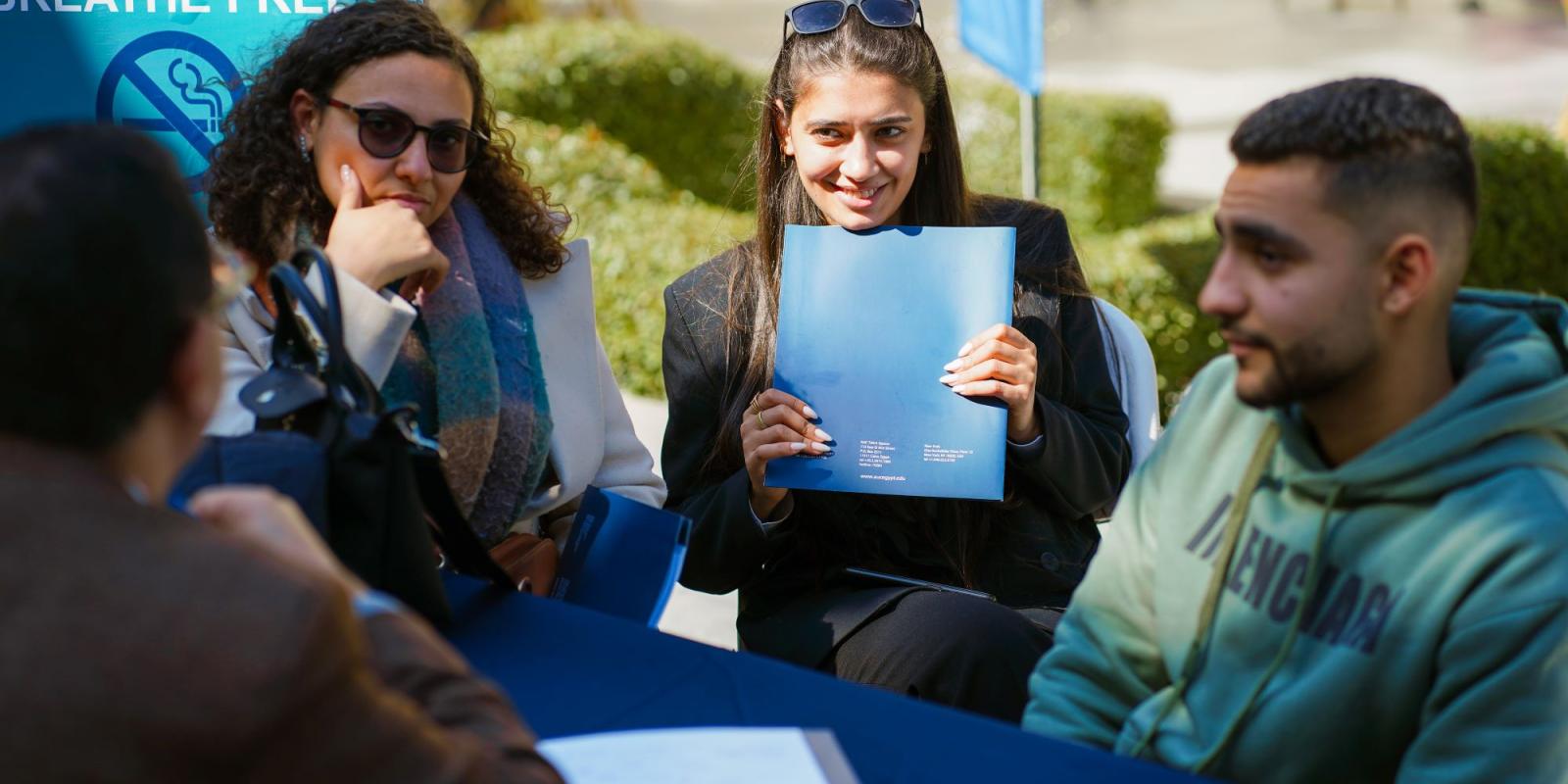 Learners asking for information at AUC's SCE event