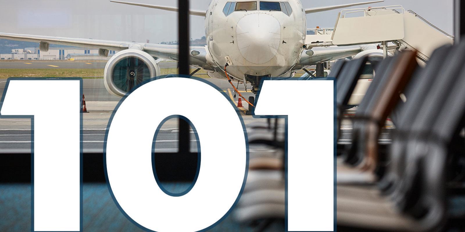 A plane in an airport. Text: 101