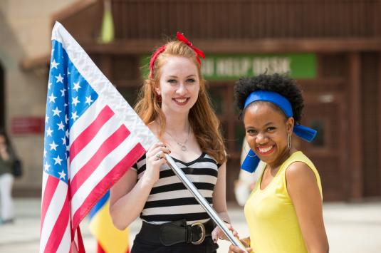 two students holding the american flad