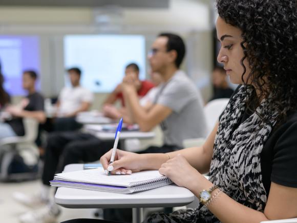 student taking notes in class