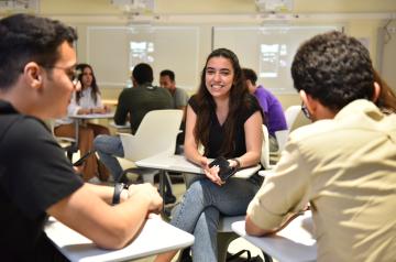 female student smiling in a classroom