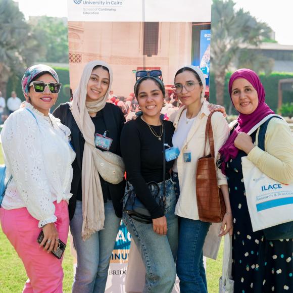 group of students smiling to the camera in tahrir