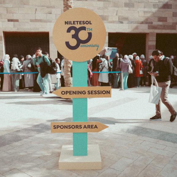 Registration line for NileTESOL 2026 with a direction arrows with 30th anniversary logo 