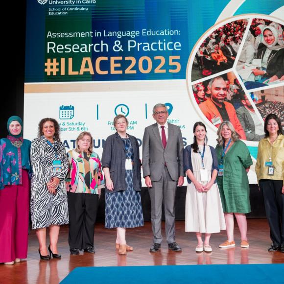 ILACE 2025 committee taking a group photo in the stage of Ewart Hall